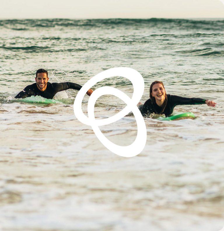 Couple surfing on the Sunshine Coast